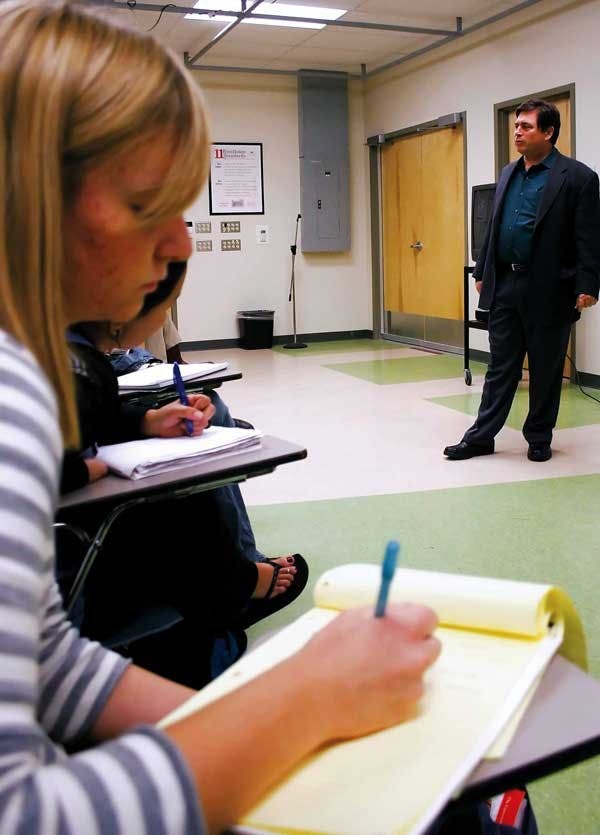 UNM student Laura Rasmussen takes notes during a lecture by Michael Roth in the Communication and Journalism building on Monday. Roth is a U.S. Foreign Service Officer stationed in Cameroon. 