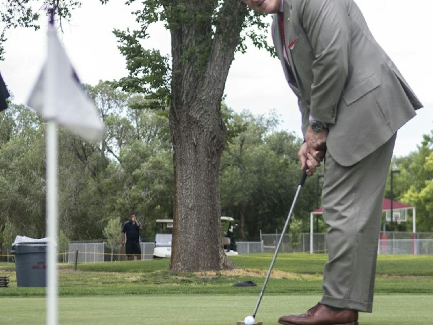 	UNM President Robert Frank putts during the opening ceremony of the North Campus golf course Friday afternoon. Representatives from the University, Bernalillo County and the north campus neighborhood gathered to celebrate course renovations. Frank said the improvements will help with water conservation and demonstrate effective collaboration between the University, the county and the surrounding community. 

	“We’re thrilled that we reached this accomplishment,” he said. “We have many more accomplishments that we want to do with Bernalillo County in the future.”

	Tim Davis, vice president of the North Campus Neighborhood Association, said the project should save millions of gallons of water. Golf course revenue has gone up 30 percent this year, he said, with an average of 500 people per day using the area.

	“A significant piece of the identity of the UNM campus is in the process of being restored,” he said. 