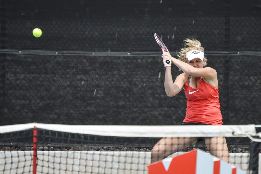 Junior Emily Oliver returns the ball during a singles match Sunday April 24, 2016 at the McKinnon Family Tennis Stadium.