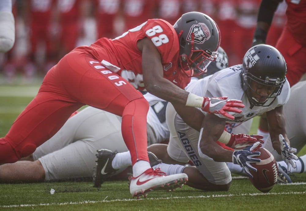 Lobo tight end Marcus Williams and Aggie Cornerback Cameron Haney contest a loose ball after  Lobo quarterback Lamar Jordan&nbsp; fumbled in the 1st quarter, November 6, 2017. The Lobos were defeated by Utah State 24-10 at Dreamstyle Stadium.
