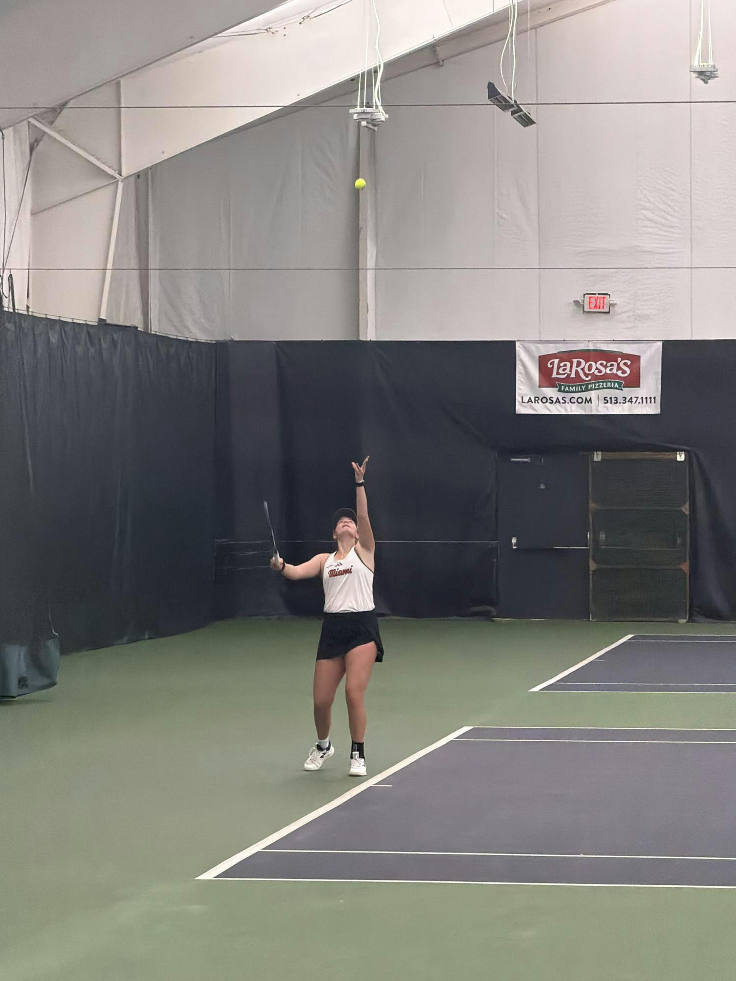 Freshman Allie Faulkner prepares to serve in a singles match