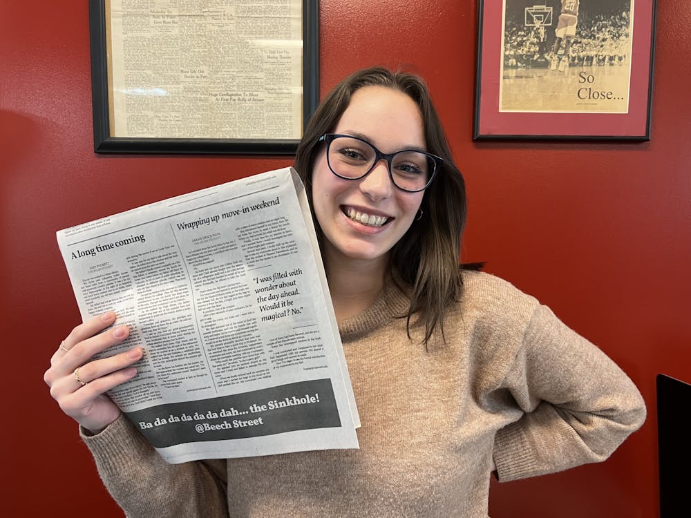 <p>Audio Editor Sarah Grace Hays with her first story in the print edition of The Miami Student.</p>