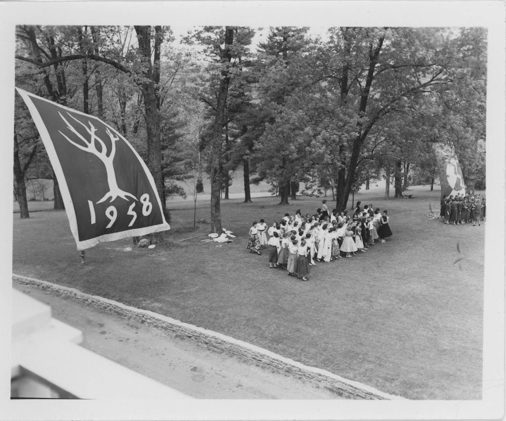 Western College for Women students gathered around 1958 and 1956 class flags on Tree Day, circa 1955-1959. Photo from Western College Archives.