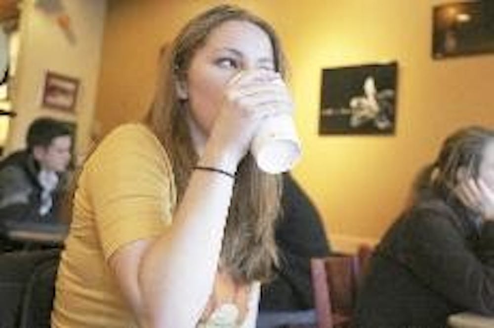 Miami junior Ali Falcon sips on coffee at Starbucks uptown.