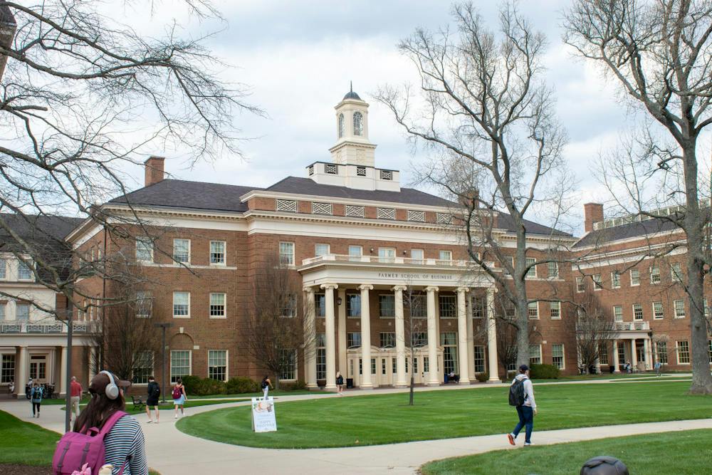 Students walk in front of Farmer School of Business.