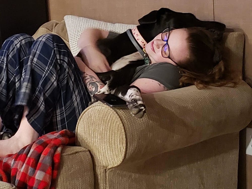 Staff writer Chloe Southard takes a nap with her beloved Great Dane, Lolita.