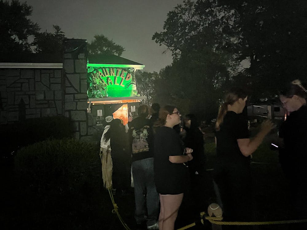 Visitors stand in line to enter the Mt. Healthy Haunted House, which offers a different experience from a traditional haunted house.