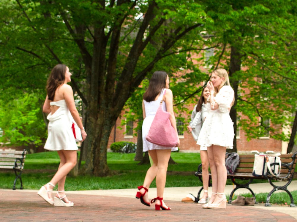 Confetti litters the ground around the seal, a popular spot for graduation photos.