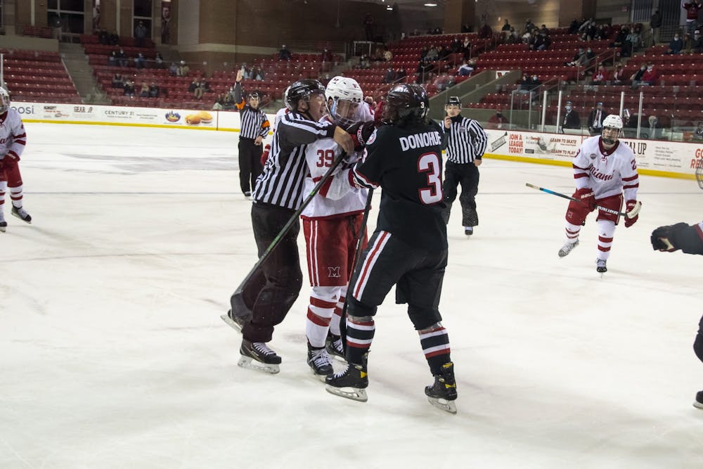 Senior forward Casey Gilling (pictured, middle) had to be restrained during the 3rd period of Friday&#x27;s win over St. Cloud.
