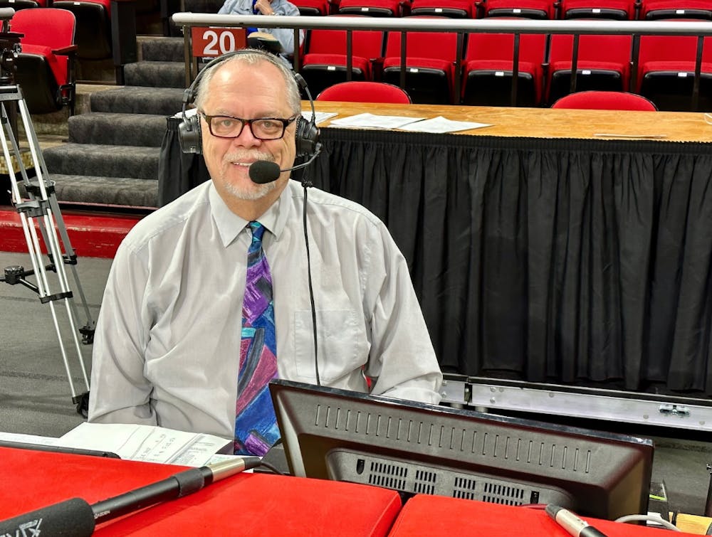 Miami University Director of Broadcasting, Steve Baker, sits at the media table preparing to call a men’s basketball game against Eastern Illinois.