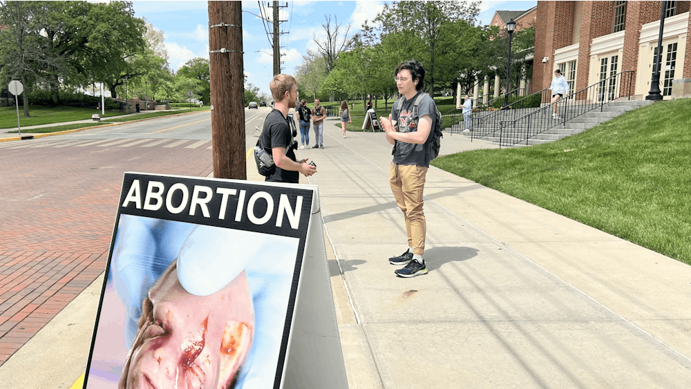 The organization "Created Equal" stands outside Armstrong Student Center to advocate their pro-life stance