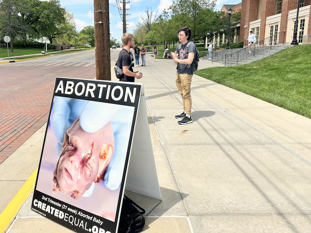 The organization "Created Equal" stands outside Armstrong Student Center to advocate their pro-life stance