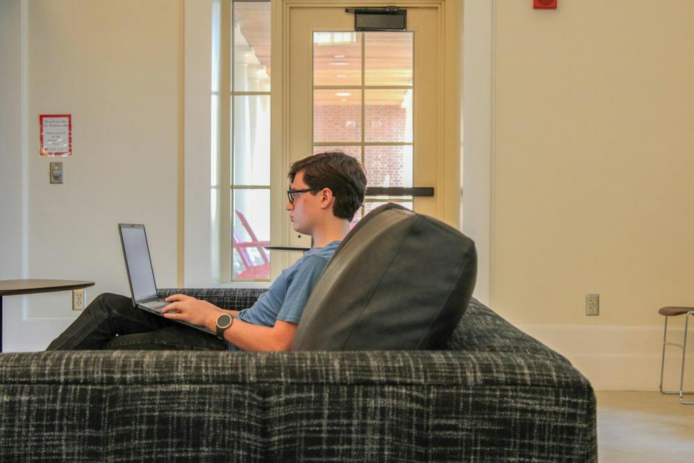 A student studies in the Shade Family Room in the Armstrong Student Center.