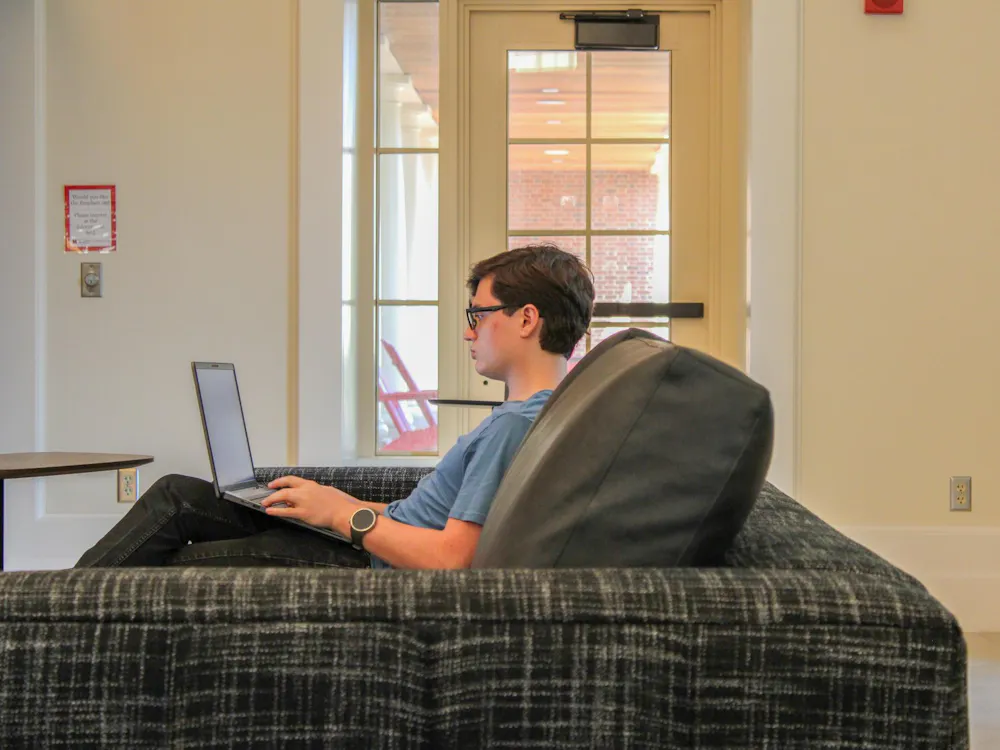 A student studies in the Shade Family Room in the Armstrong Student Center.