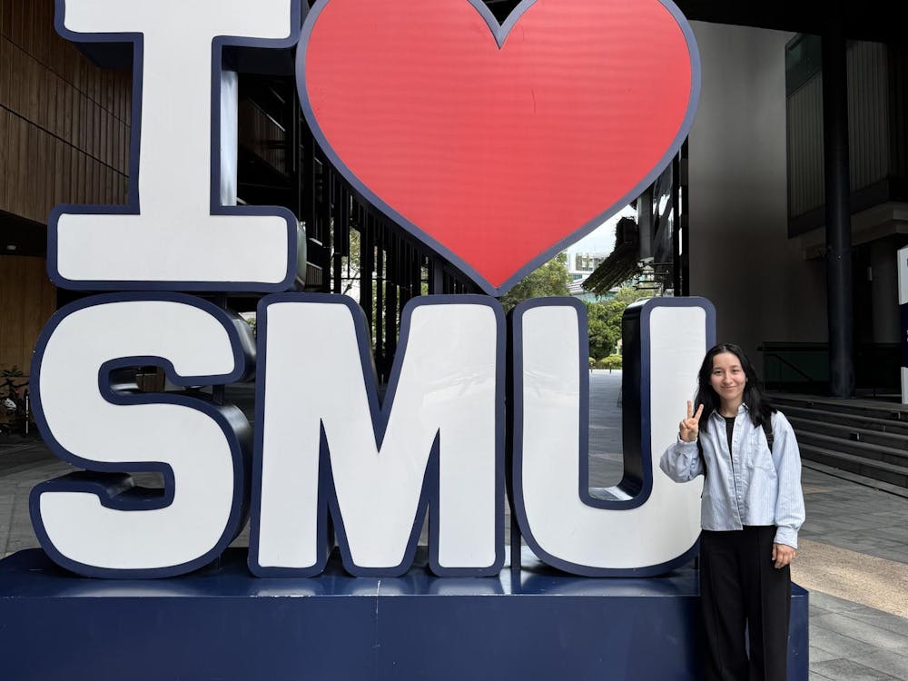 Mahfiza standing beside the “I