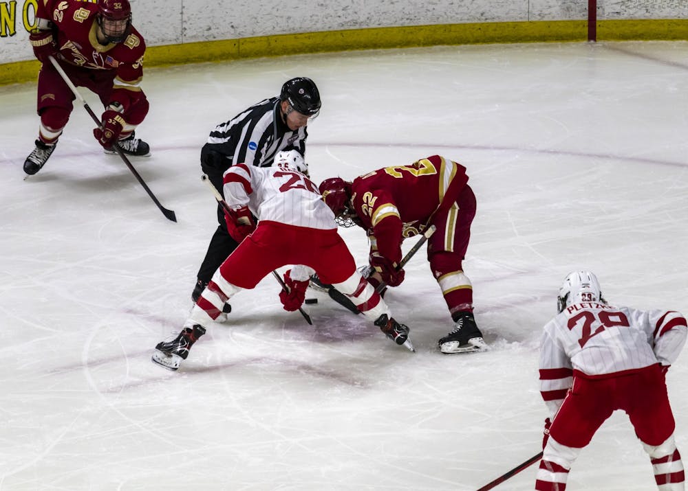 <p>Senior forward Matt Barry faces off against Denver forward Connor Caponi in a weekend series against the Pioneers.</p>