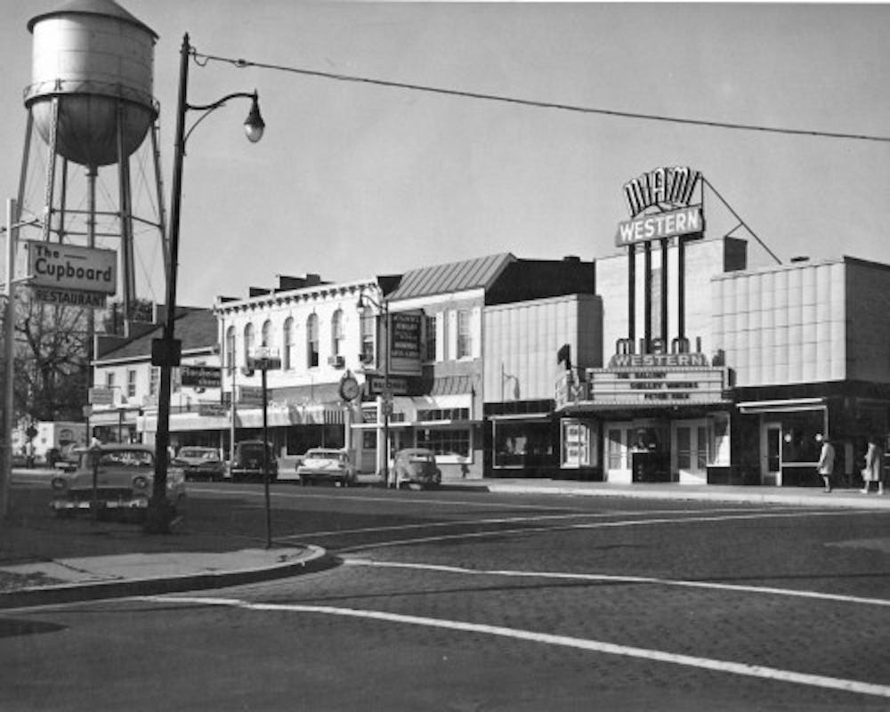 The corner of High Street and Poplar Street in 1963, featuring the Miami-Western Theatre, which is now known as Brick Street Bar. 