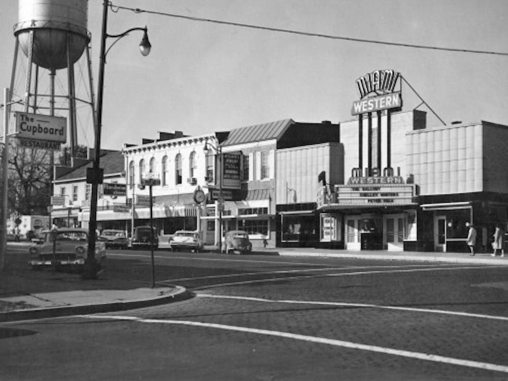 The corner of High Street and Poplar Street in 1963, featuring the Miami-Western Theatre, which is now known as Brick Street Bar. 