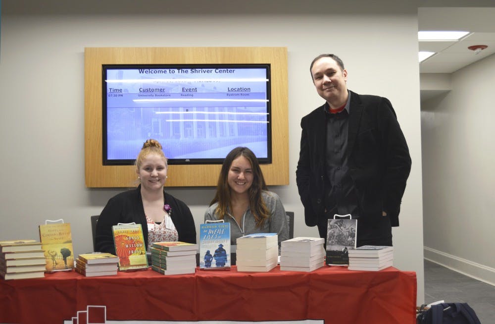 Jamie Ford and Hannah Trinti sell their books outside of the Heritage Room in the Shirver Center.