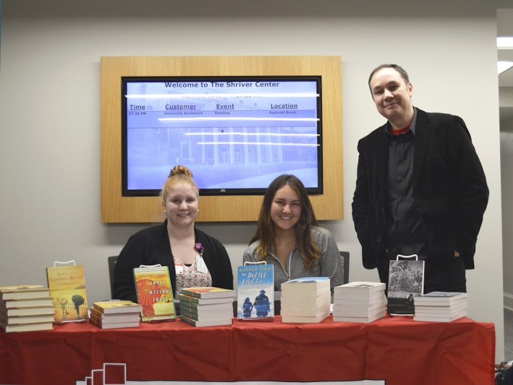 Jamie Ford and Hannah Trinti sell their books outside of the Heritage Room in the Shirver Center.
