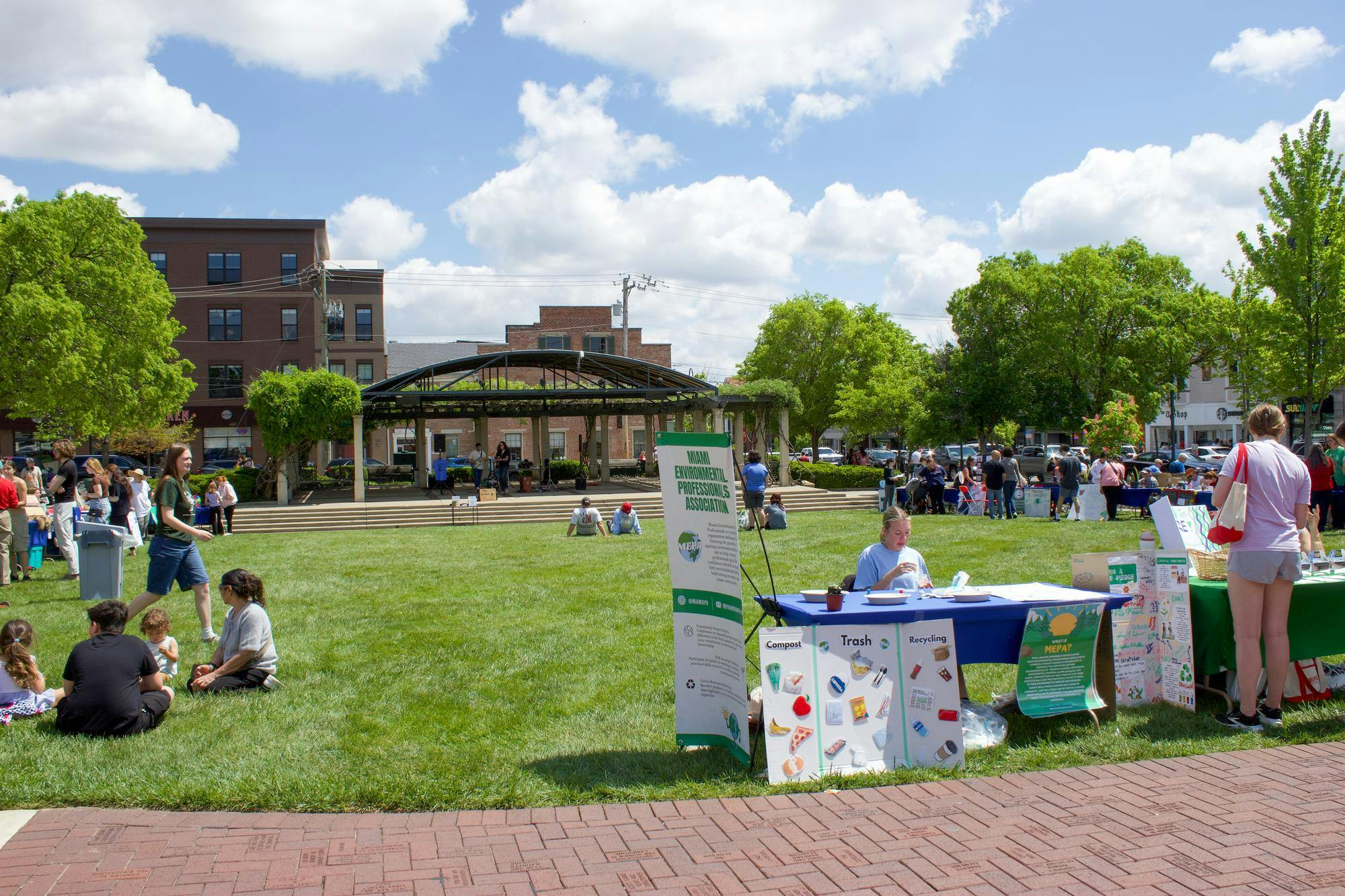 People visit the Miami Environmental Professionals Association booth at Earth Fest in Uptown Oxford. 