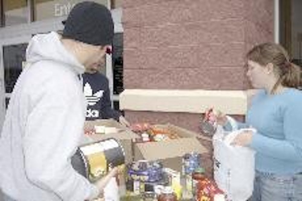 Miami students drop off canned goods outside Wal-Mart as part of the Gravy Days' effort to collect food for the Family Resource Center. 