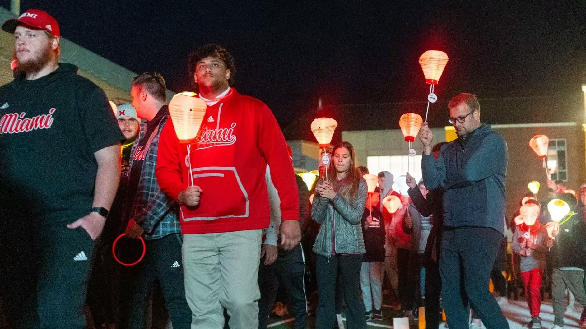 Attendees walking and carrying lanterns at last year&#x27;s Light the Night﻿