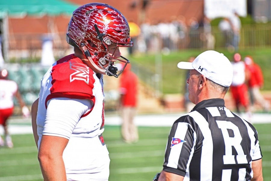 Freshman quarterback Billy Bahl chats with a referee before the OU game.