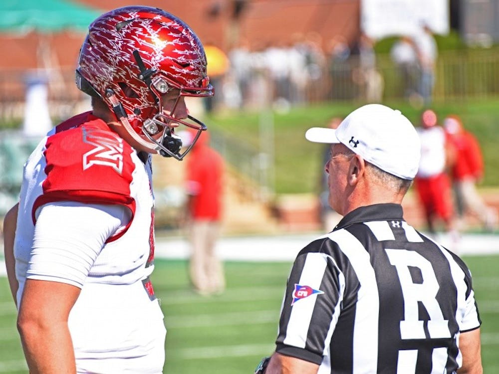 Freshman quarterback Billy Bahl chats with a referee before the OU game.