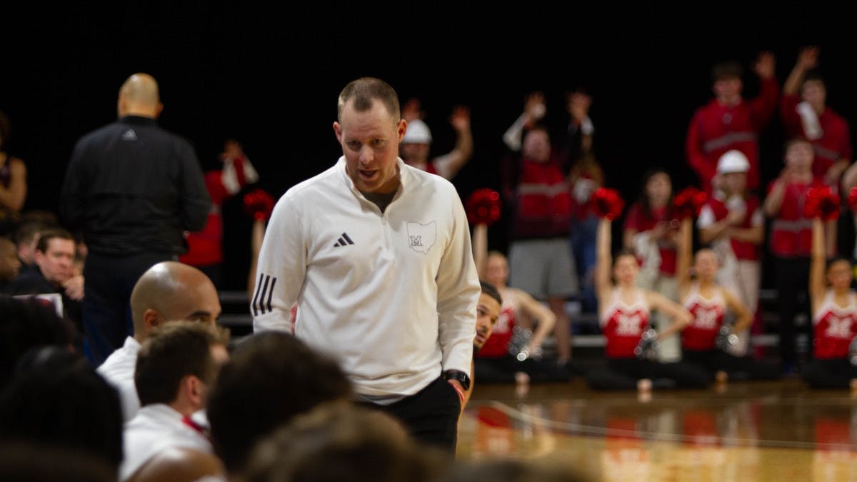 Miami head coach Travis Steele walking along the sidelines of the RedHawks’ bench at Millett Hall on February 11, 2024 for a home game against the Central Michigan Chippewas. Steele finished his second season at Miami with a 15-17 overall record and a 9-9 conference record.
