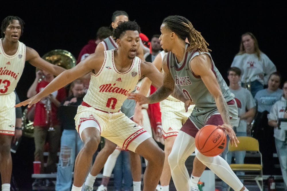 <p>Eian Elmer guarding Ketron Shaw in the second half on Tuesday night. Elmer scored a career-high 24 points, including a 13 in a row to give Miami the advantage in the final minutes</p>