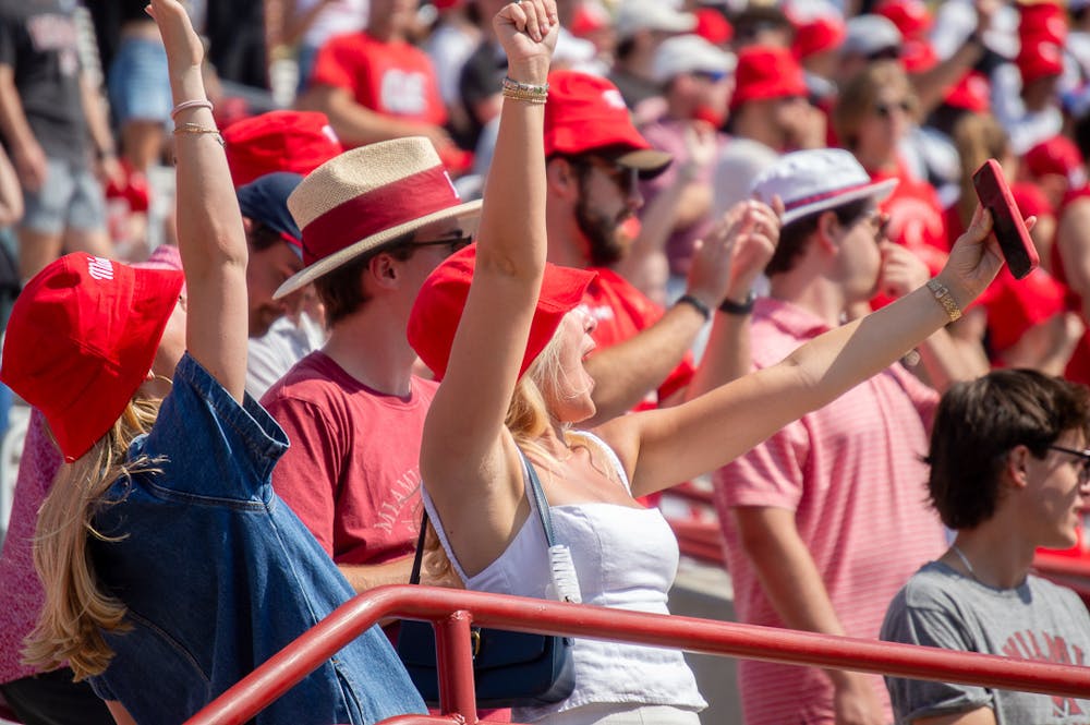 Miami fans cheer at a football game at Yager Stadium against the University of Cincinnati. 