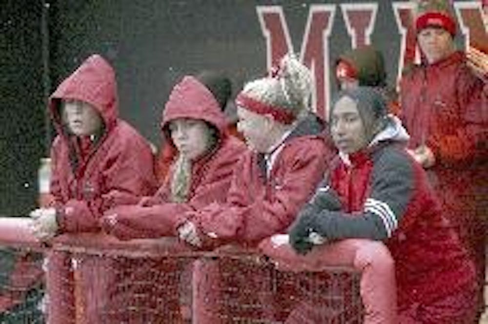 Miami softball players brave the freezing cold termperatures during Sunday's doubleheader against the Broncos.
