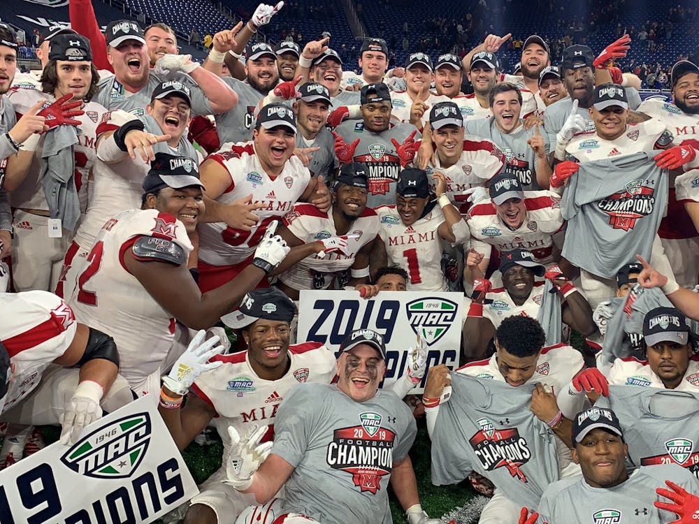 The Miami RedHawks hold up their Mid-American Conference Champions shirts during the postgame celebration Saturday at Ford Field.
