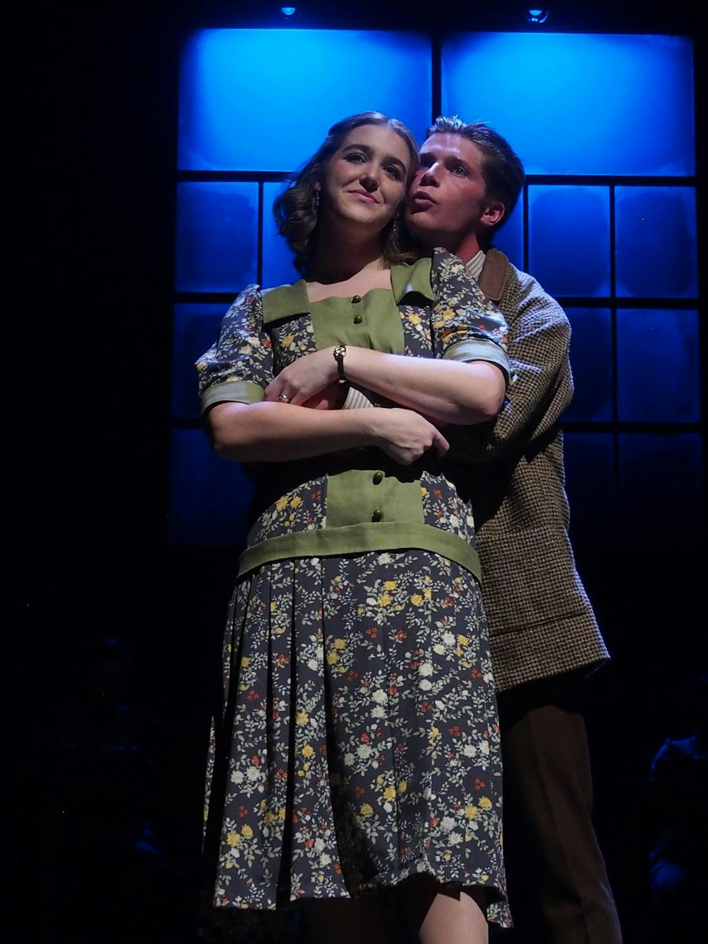 Catherine Donohue (played by junior Tammy Sanow) and her husband Tom (played by senior Drew Grant) embrace. These Shining Lives highlights Catherine and Tom's relationship as her health deteriorates after working for Radium Dial.