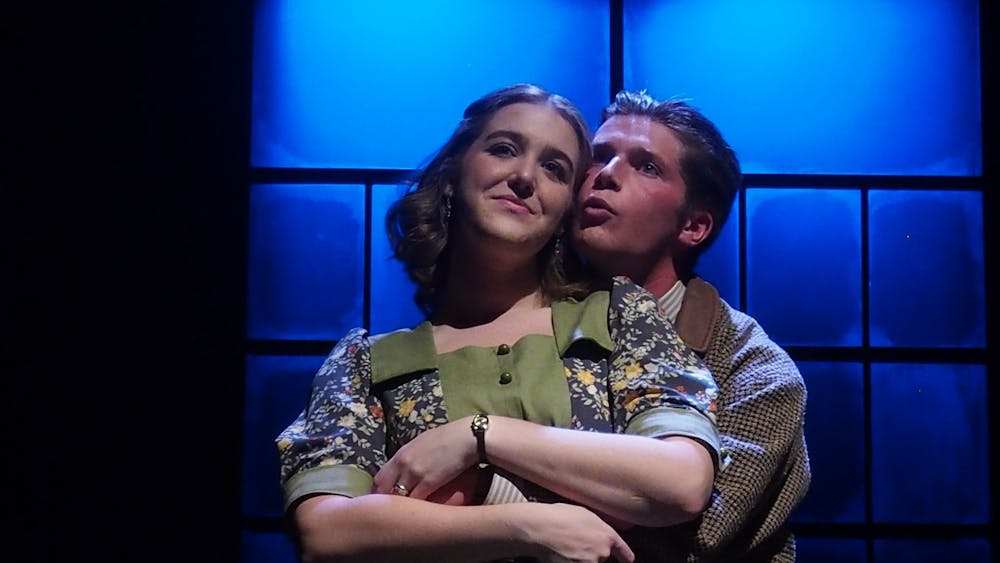 Catherine Donohue (played by junior Tammy Sanow) and her husband Tom (played by senior Drew Grant) embrace. These Shining Lives highlights Catherine and Tom's relationship as her health deteriorates after working for Radium Dial.