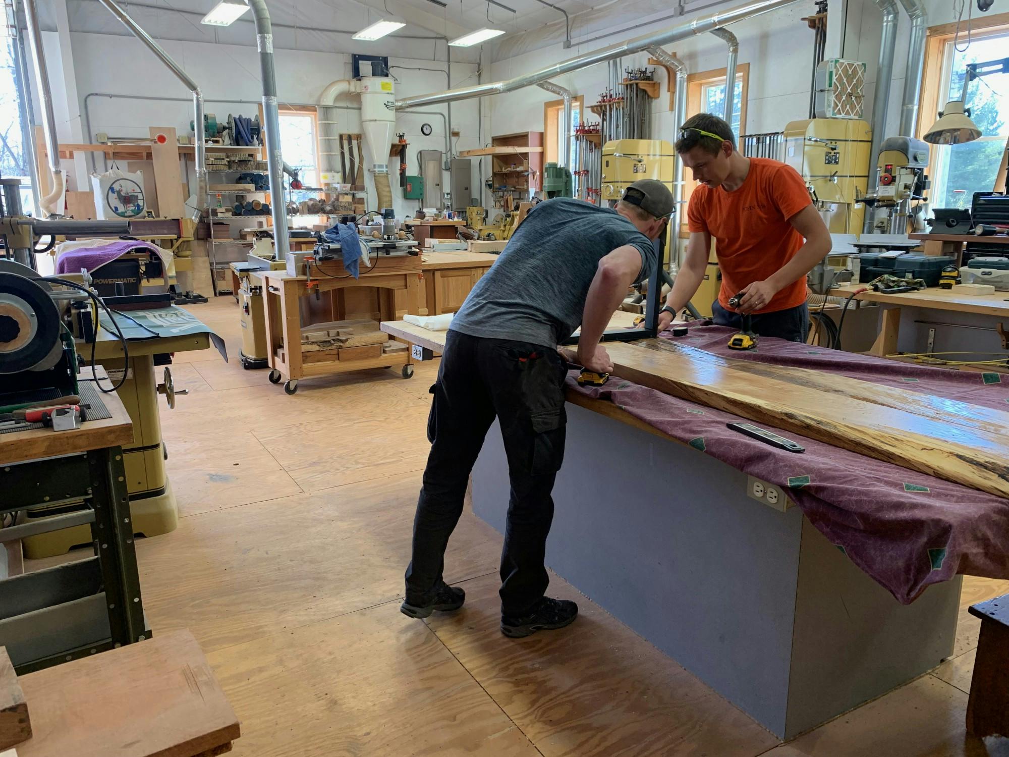 Ryan Murphy (left) and Vilppu Anttila (right) working on a bench to match the table they just finished. 