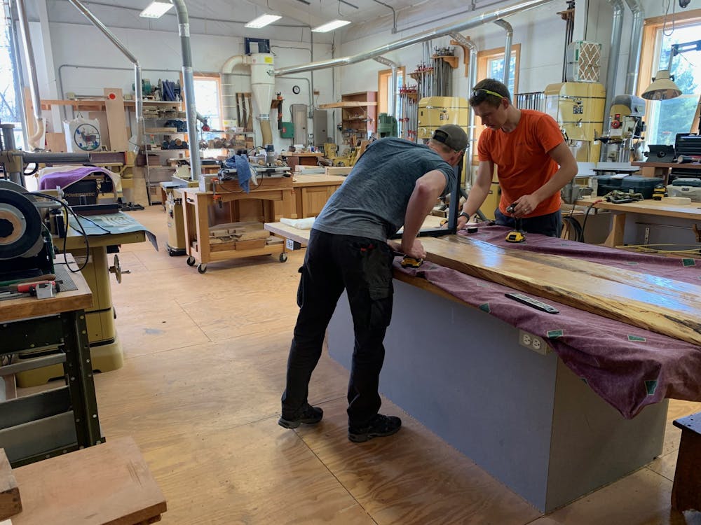 Ryan Murphy (left) and Vilppu Anttila (right) working on a bench to match the table they just finished. 