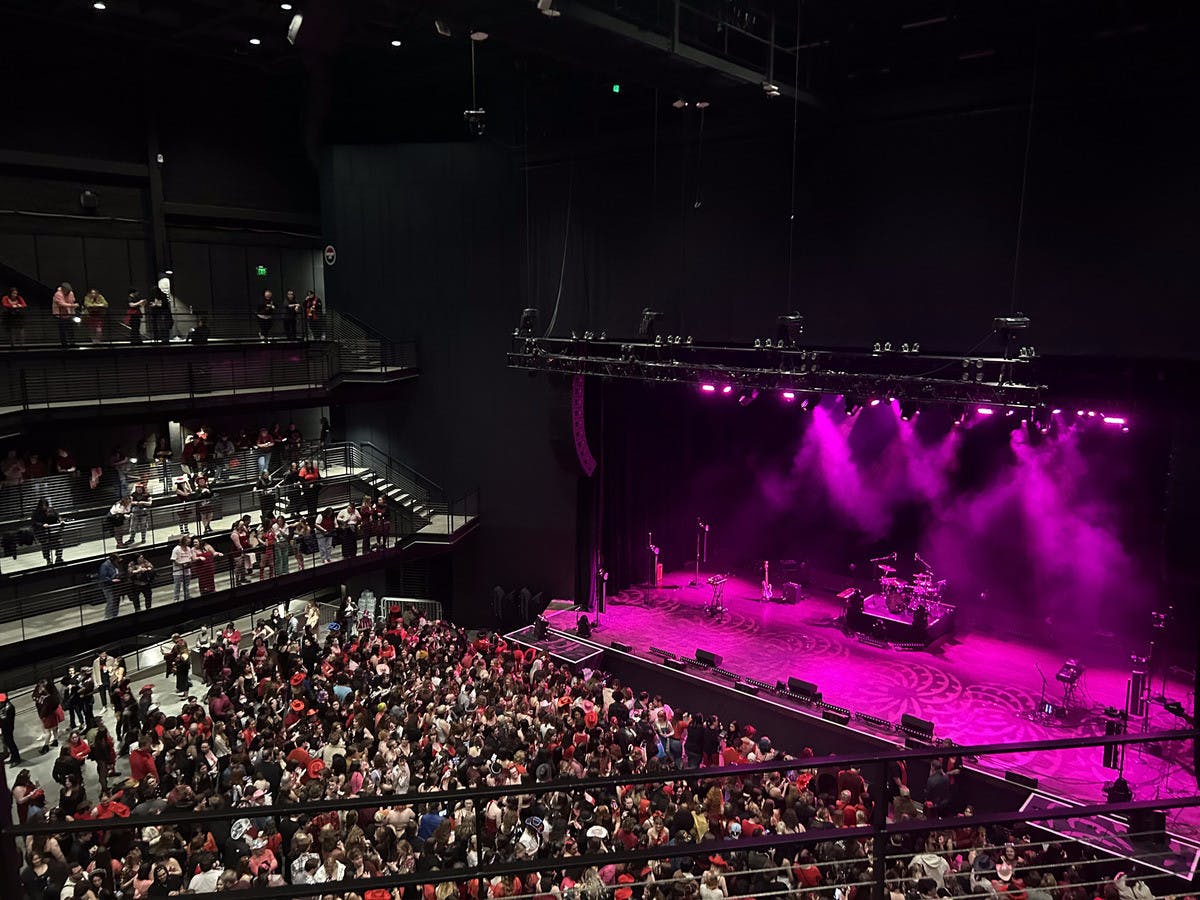 General admission attendees dressed in red and black to match the concert theme.