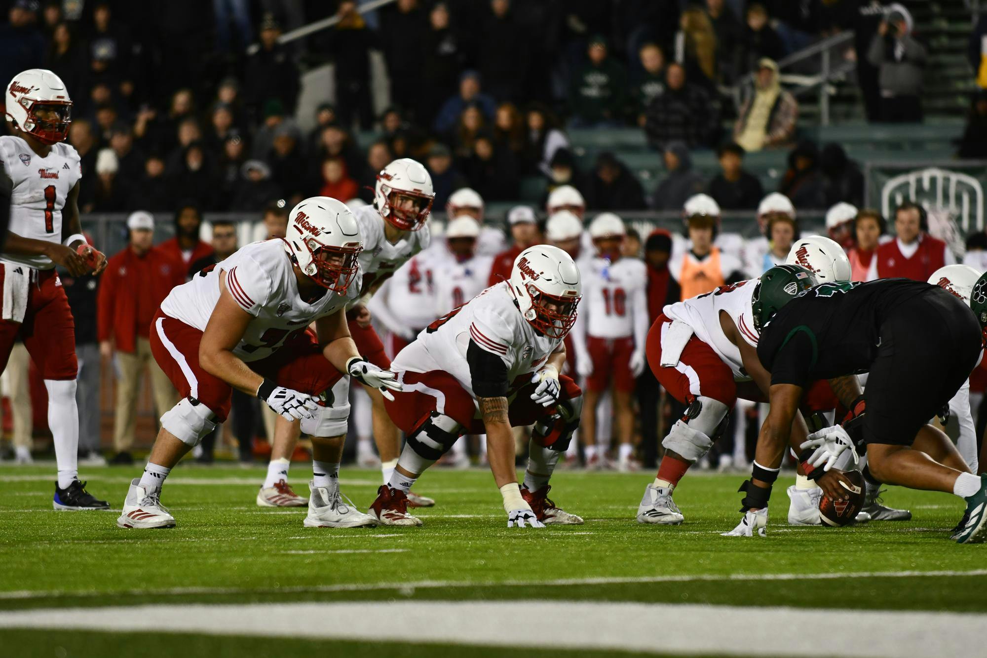 The Miami football offensive line prepares for a snap against Ohio University at Peden Stadium on Nov. 4