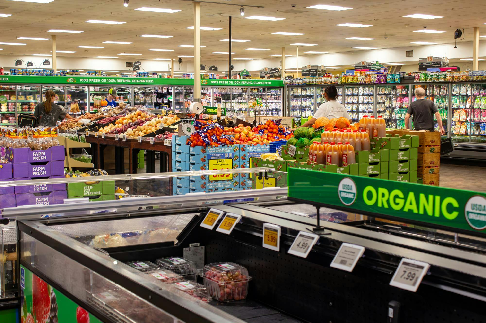 Shoppers browse the produce section at Kroger.