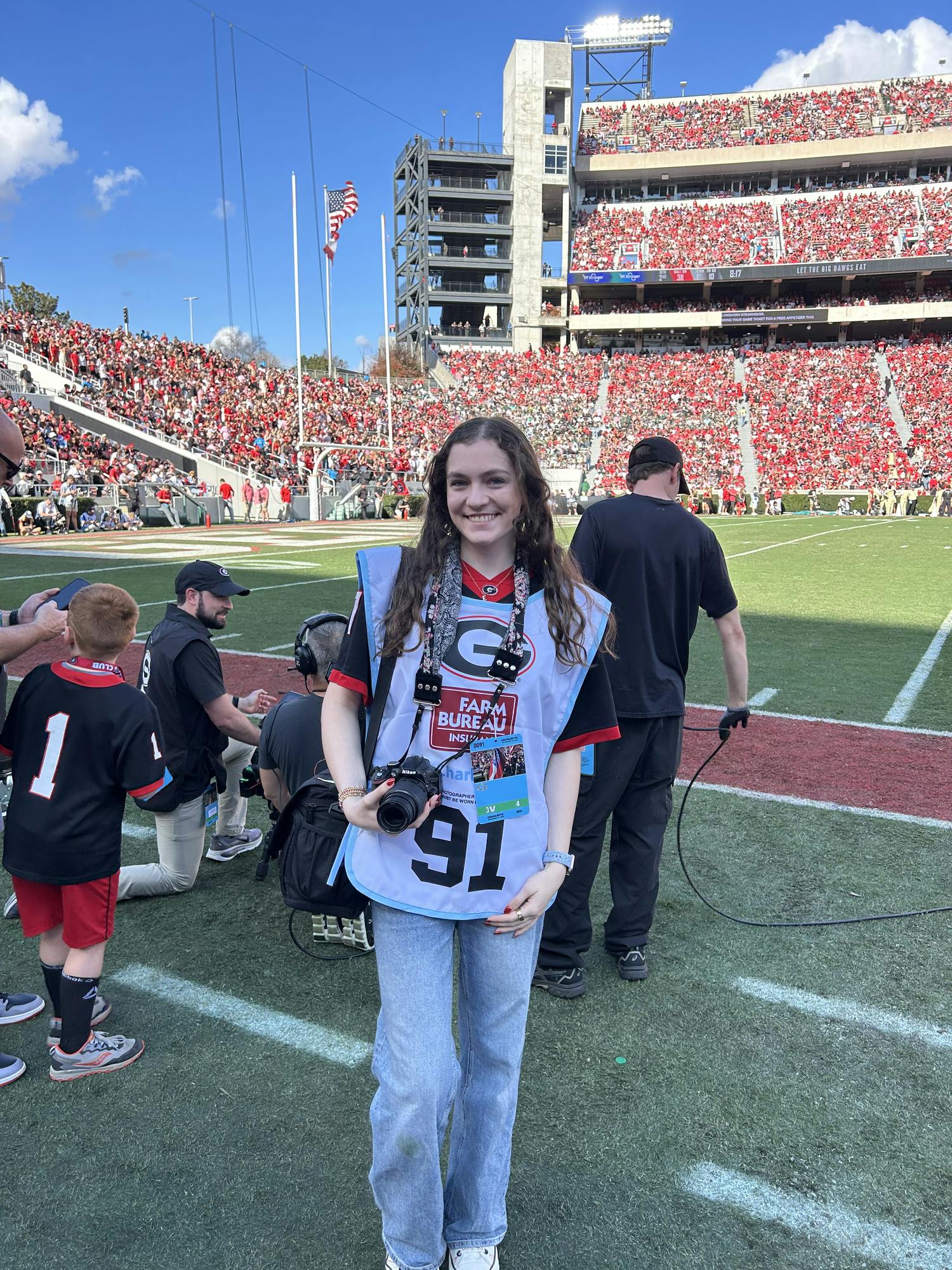 Elisa Rosenthal poses on the sideline while shooting the UGA vs. Charlotte game on Nov. 22, 2025. Photo provided by Elisa Rosenthal