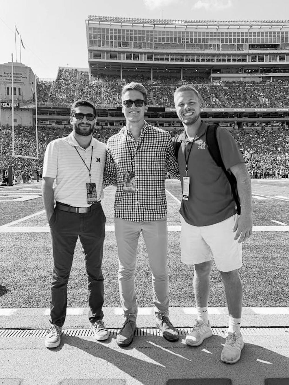 <p>Bennett Wise, Chris Vinel and Brady Pfister roam the Ohio Stadium sidelines before Miami’s football game against Ohio State in September 2019.</p>