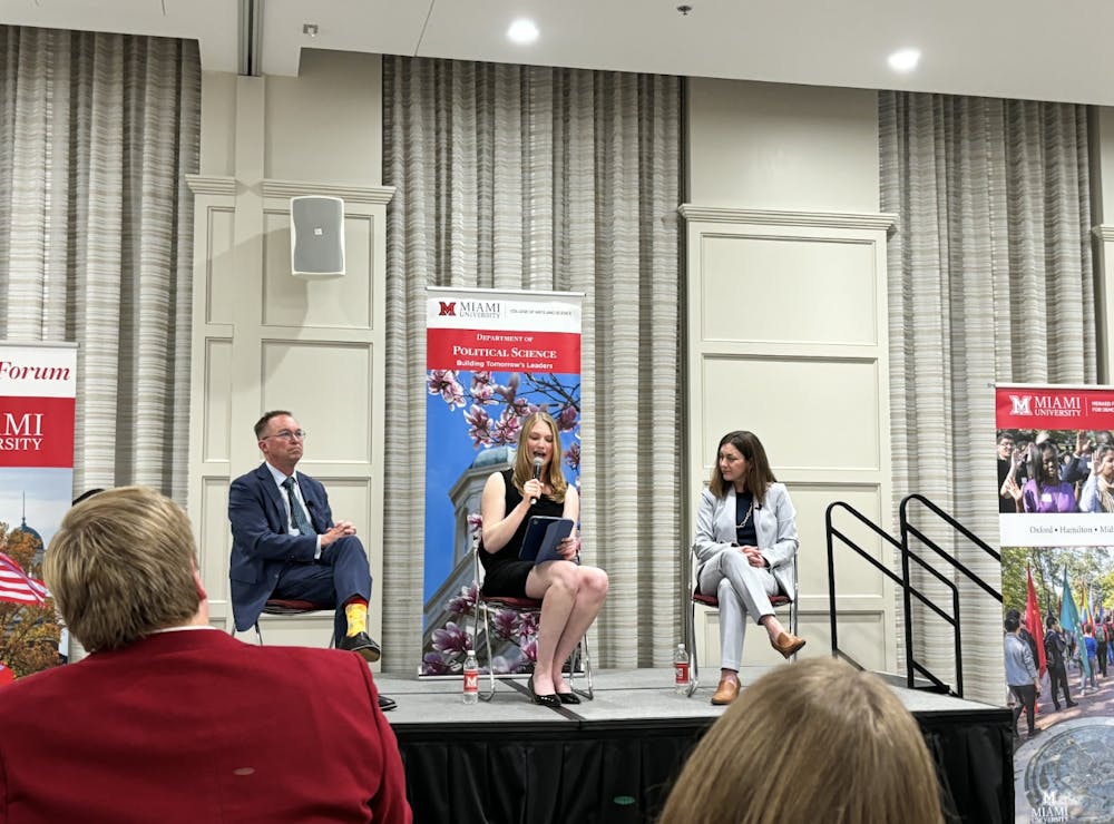 <p>Mulvaney and Muller debate election financing while junior political science student and JANUS Forum member Grace Gaston moderates.</p>