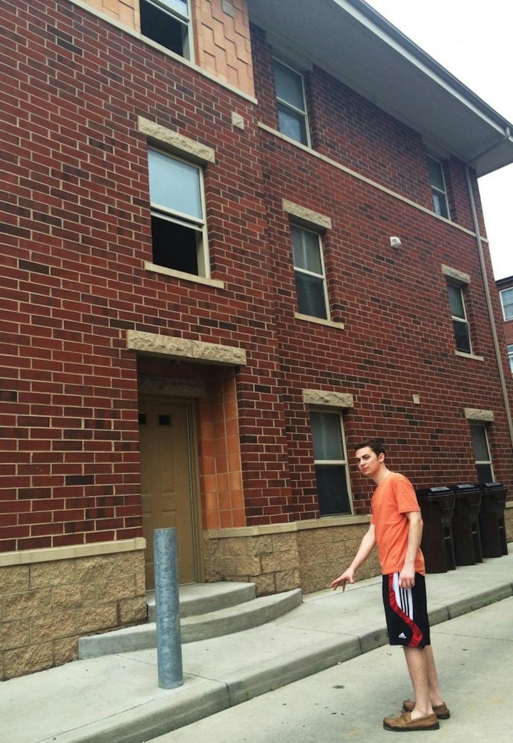 Alex Proctor points to the spot he found sophomore Caroline O’Donnell after she fell out of the third-story window above