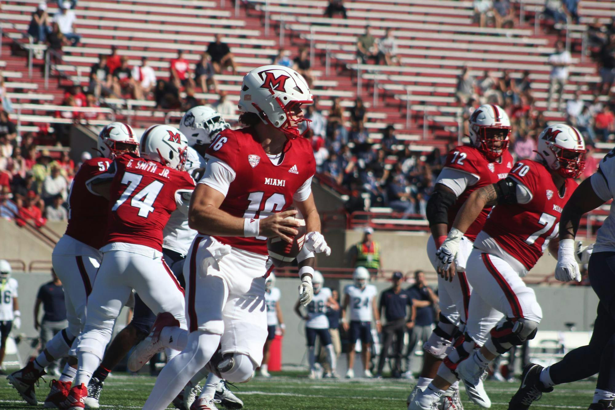 Redshirt-freshman quarterback David McComb rolls out right in game against the University of Connecticut on Sept. 26, 2026. 