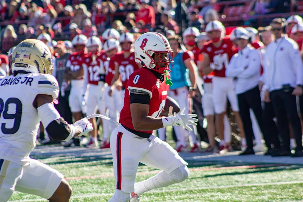 <p>Rodney Nelson runs the ball to the end zone in game against Akron</p>