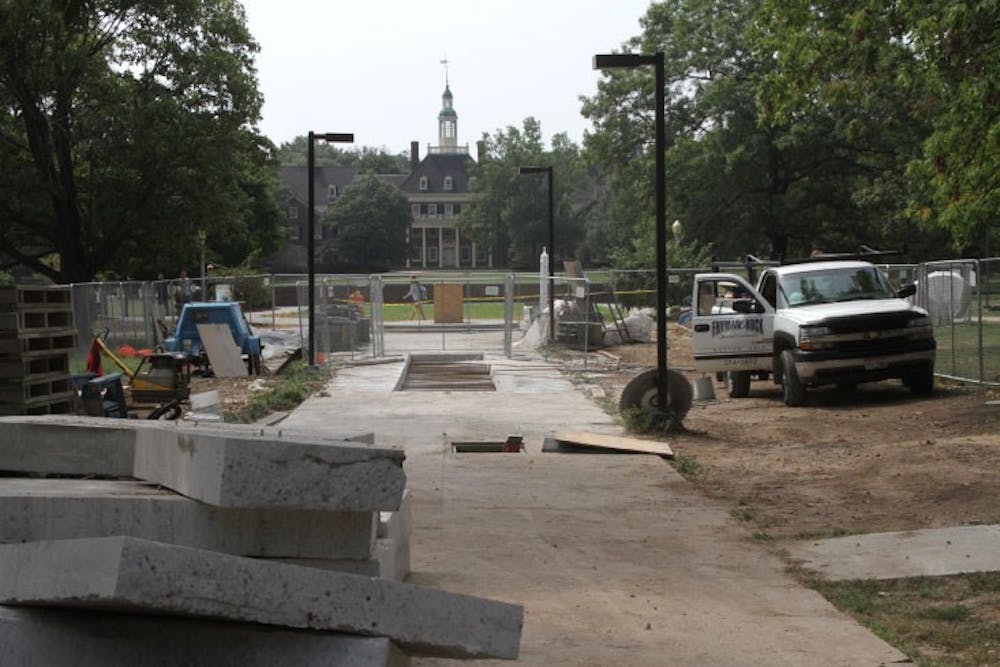 Construction workers on Central Quad are replacing deteriorating pavers and a steam tunnel top to prepare the area for the sundial, which is currently being repaired.