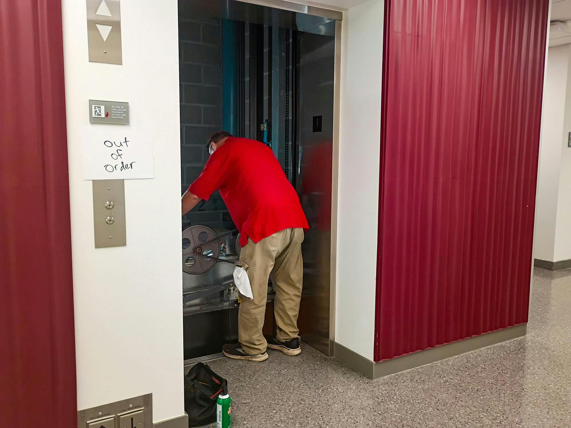 A maintenance worker fixes out of order elevator in Bachelor Hall.