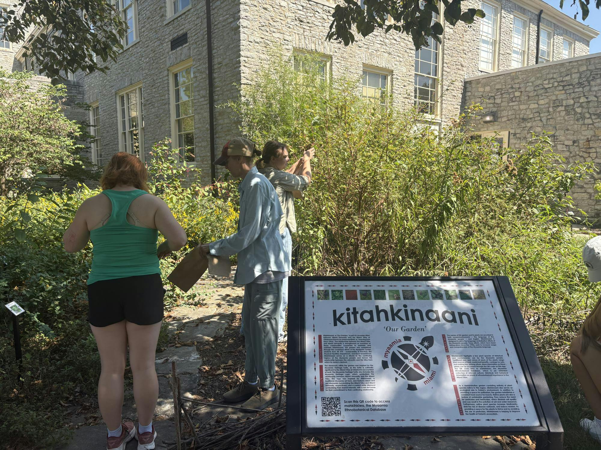 Sarah Dumyahn and students gather herbs from the Kitahkinaani garden. 